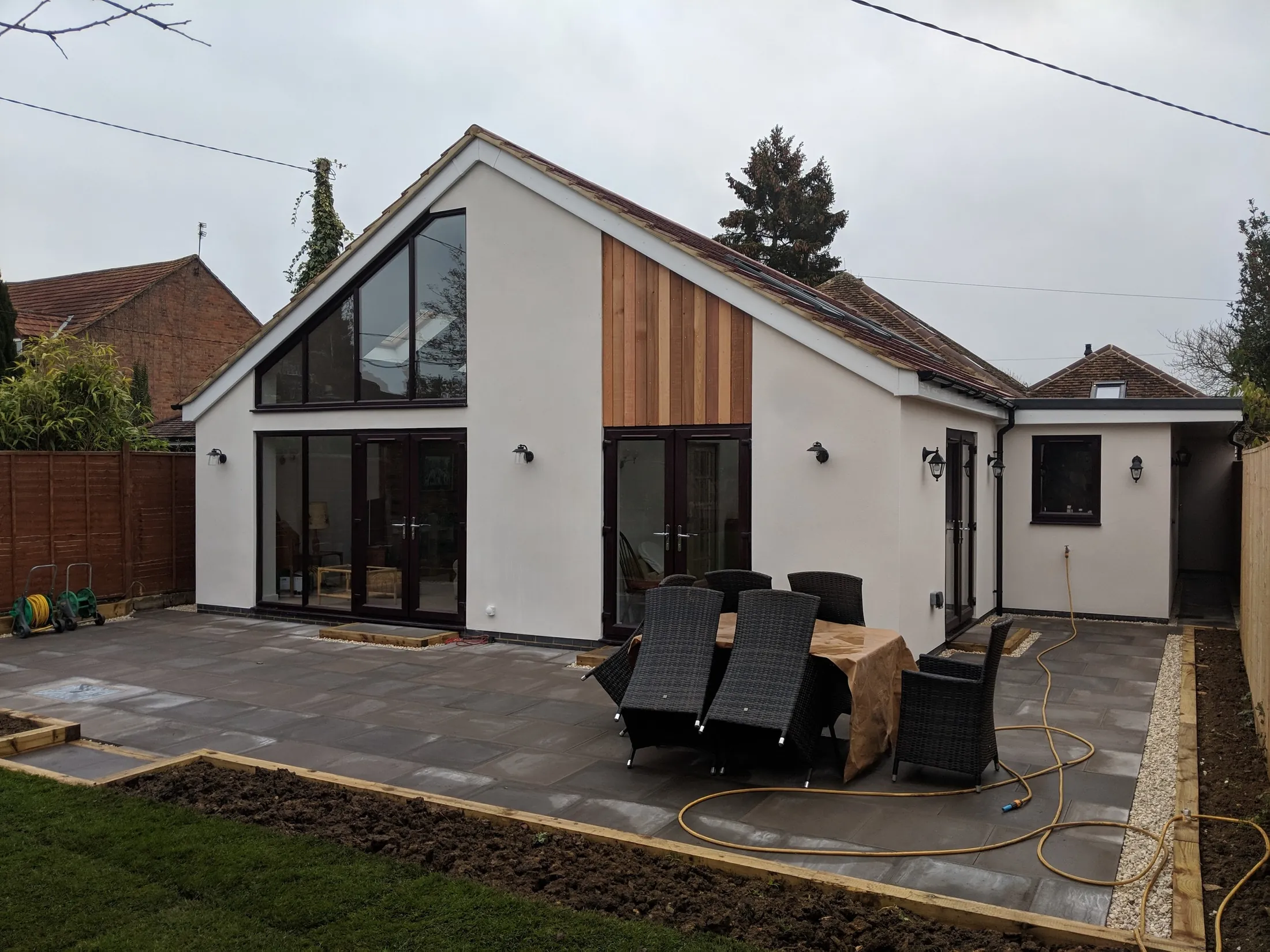 Remodelled bungalow with a glazed gable and timber-clad bay