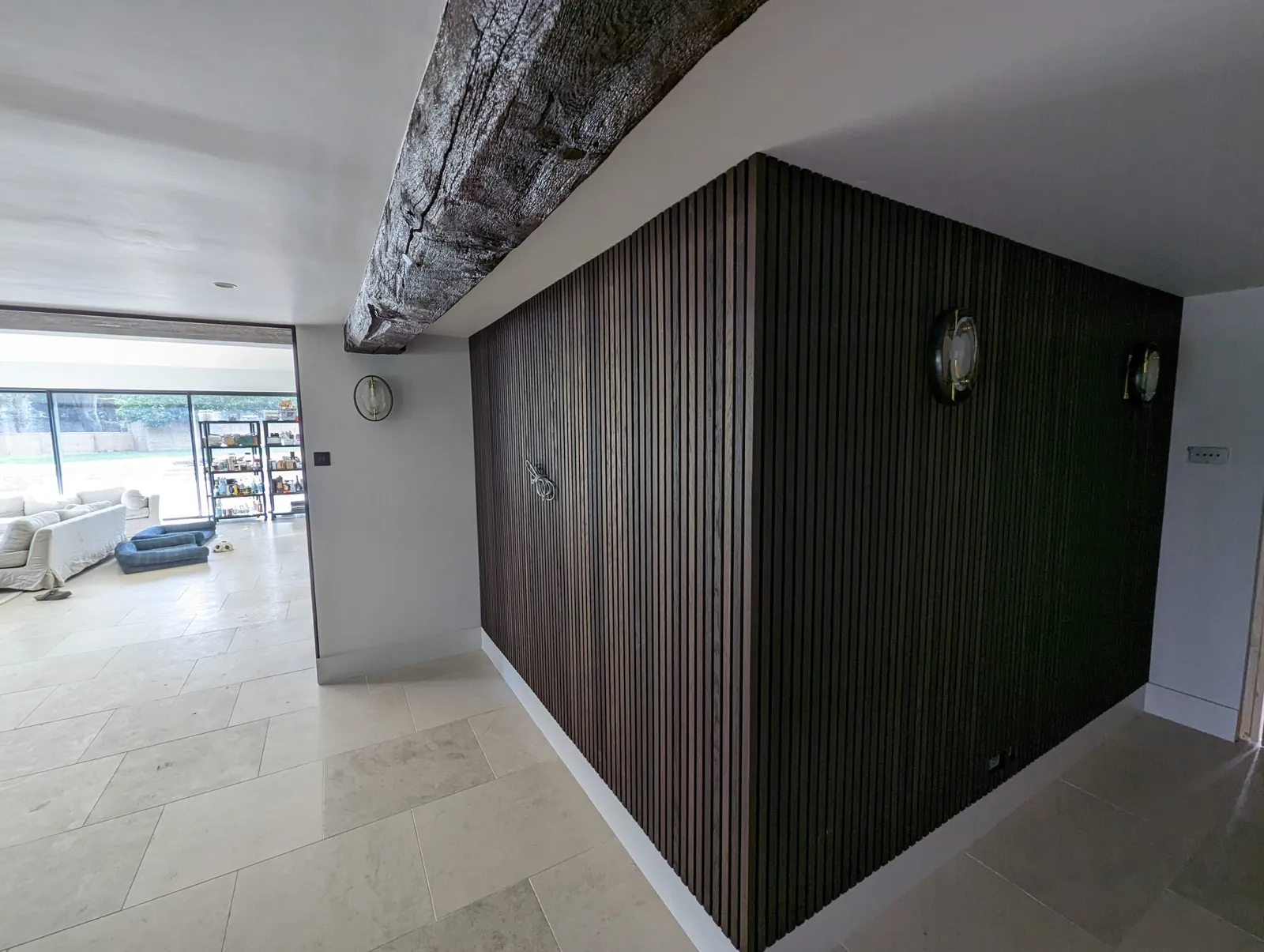 Open-plan kitchen with a dark timber slatted feature wall