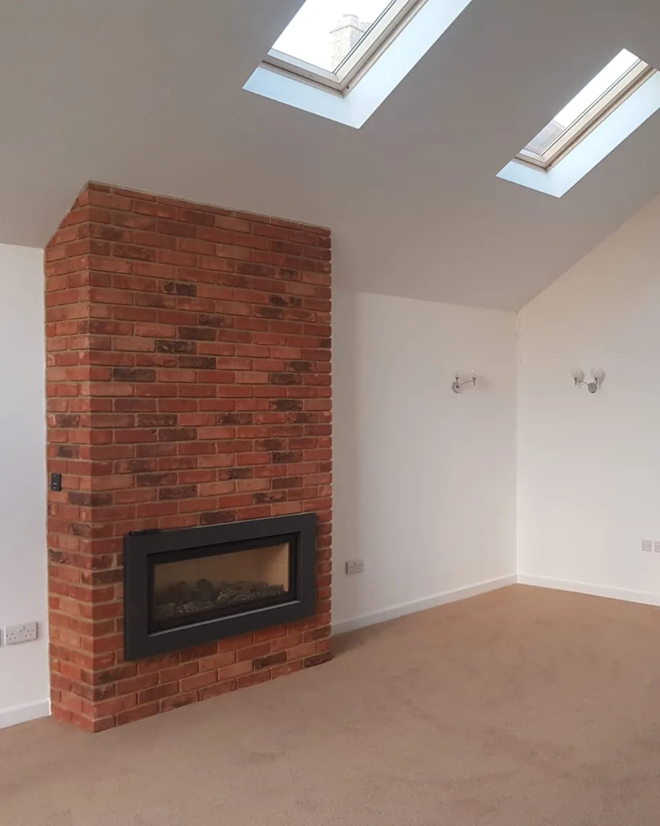 Reclaimed brick chimney breast in a vaulted living room